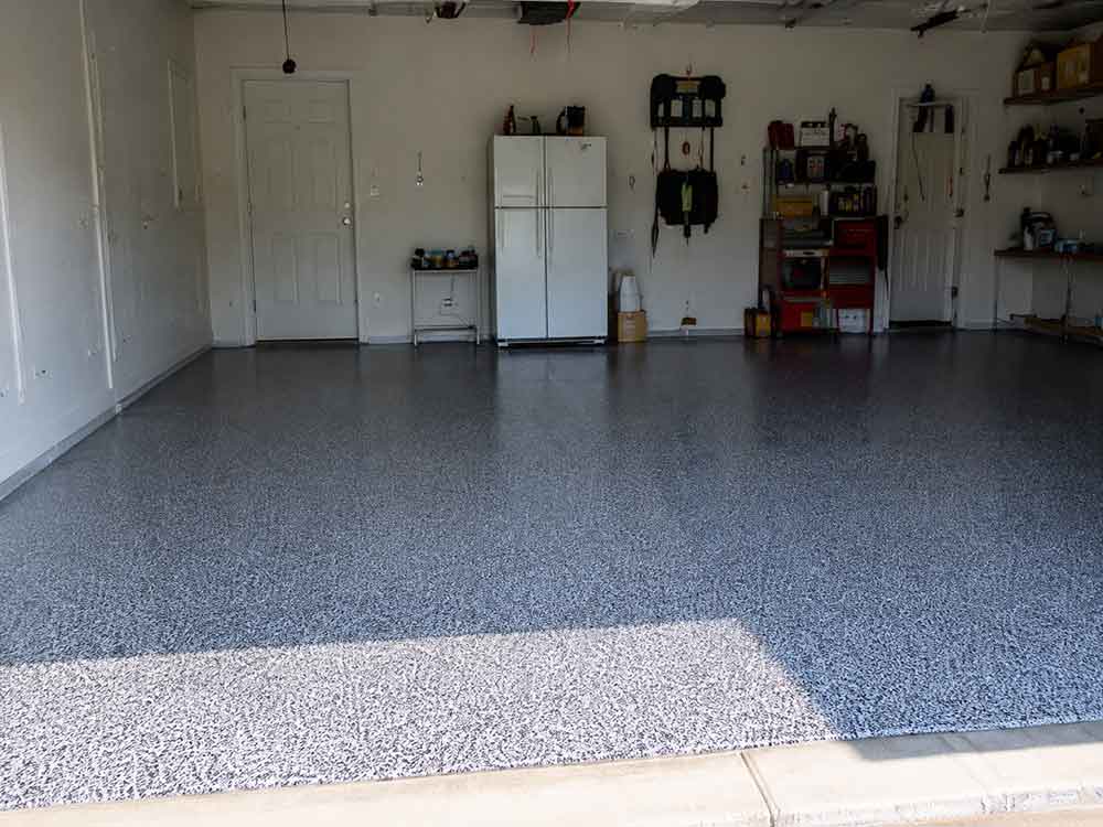 Graphite gray flake epoxy garage floor with refrigerator and storage