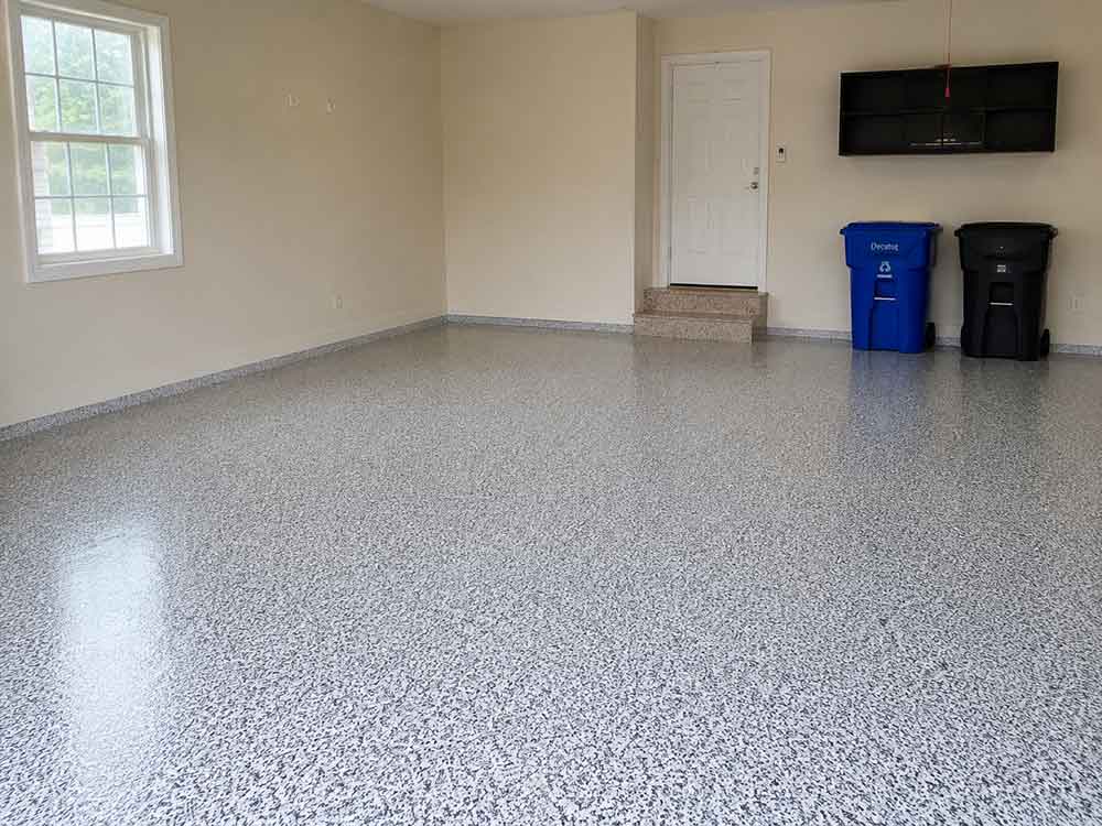 Gray flake epoxy garage floor with coated steps and cove base